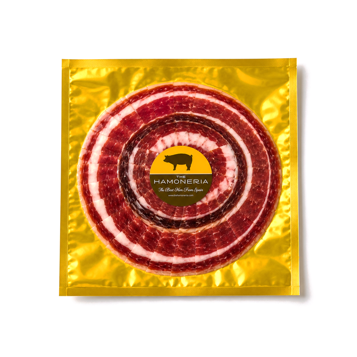 100% Iberico acorn-fed ham hand-sliced pack by Paquito Jamon on white background
